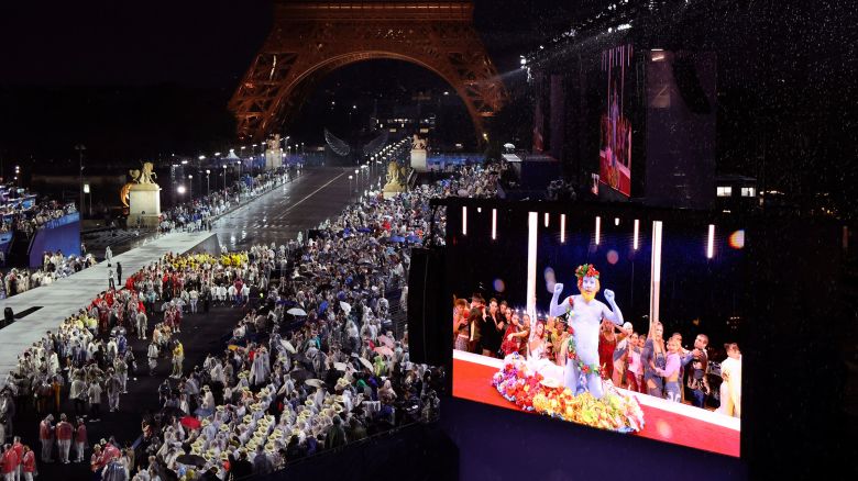 Delegations arrive at the Trocadero as spectators watch French singer Philippe Katerine performing on a giant screen, in Paris, during the opening ceremony of the 2024 Summer Olympics, Friday, July 26, 2024 in Paris.
