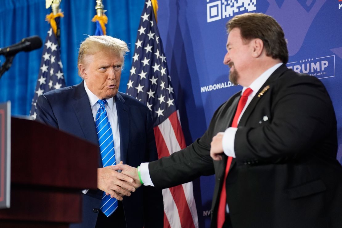 Nevada GOP chair and 2020 'fake elector' Michael McDonald, right, shakes hands with former President Donald Trump at a campaign event in January in Las Vegas.