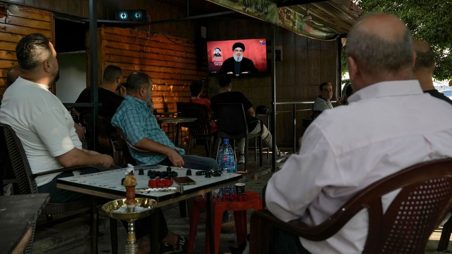 People watch a televised speech by Hezbollah leader Hassan Nasrallah at a coffee shop in a southern suburb of Beirut on August 25, 2024.