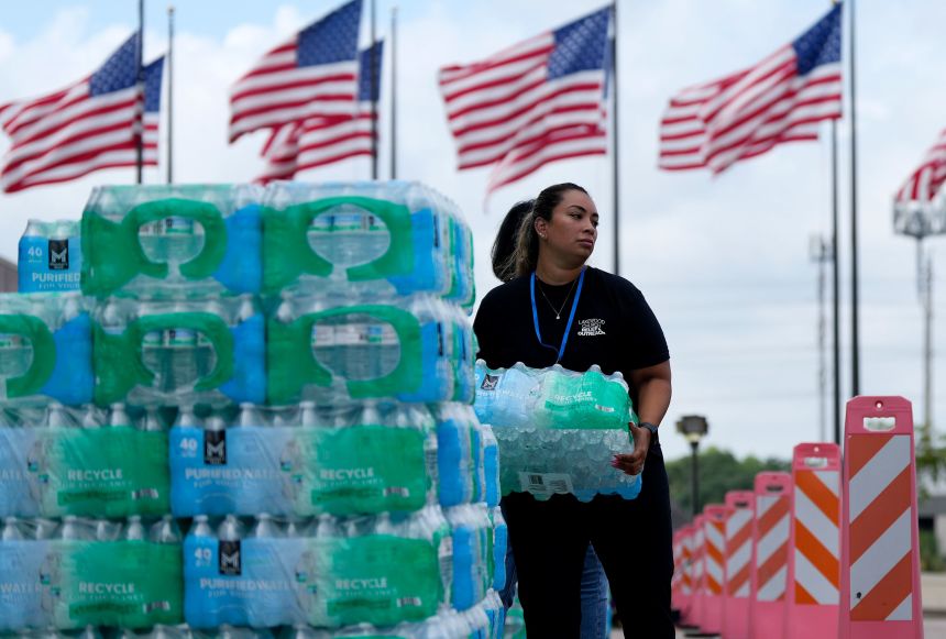 In this July 2024 photo, staff at Lakewood Church hand out water and operate a cooling station in Houston.