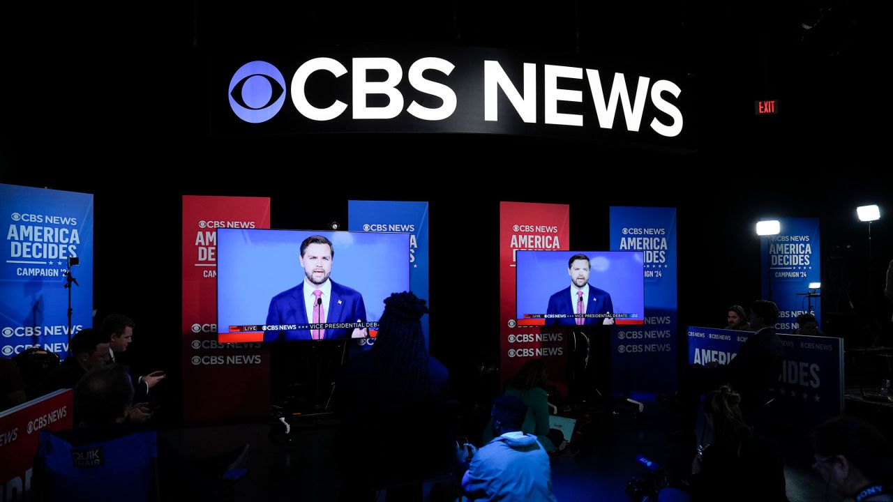 Viewers in the spin room watch the CBS News vice presidential debate on October 1 in New York. 