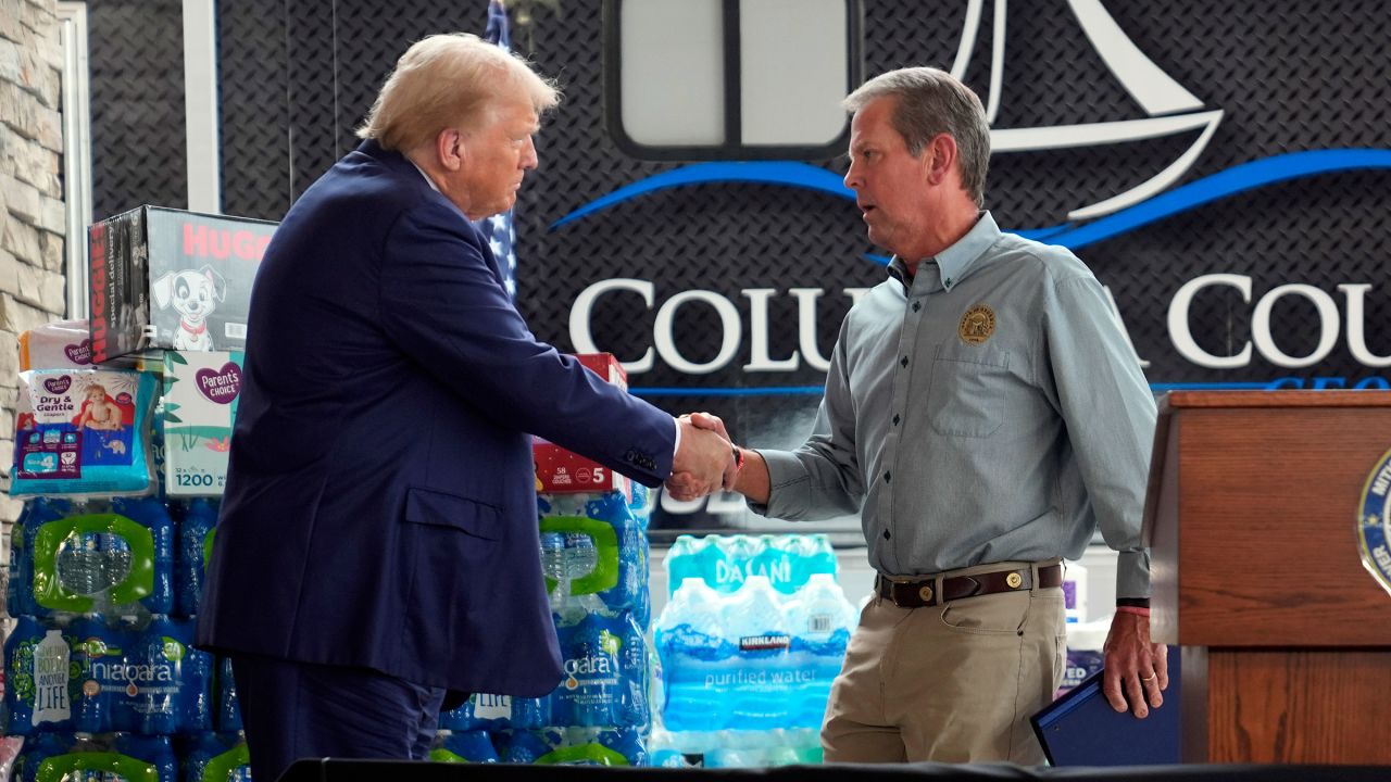 Former President Donald Trump shakes hands with Georgia Gov. Brian Kemp at a temporary relief shelter as he visits areas impacted by Hurricane Helene on Friday, October 4, in Evans, Georgia. 