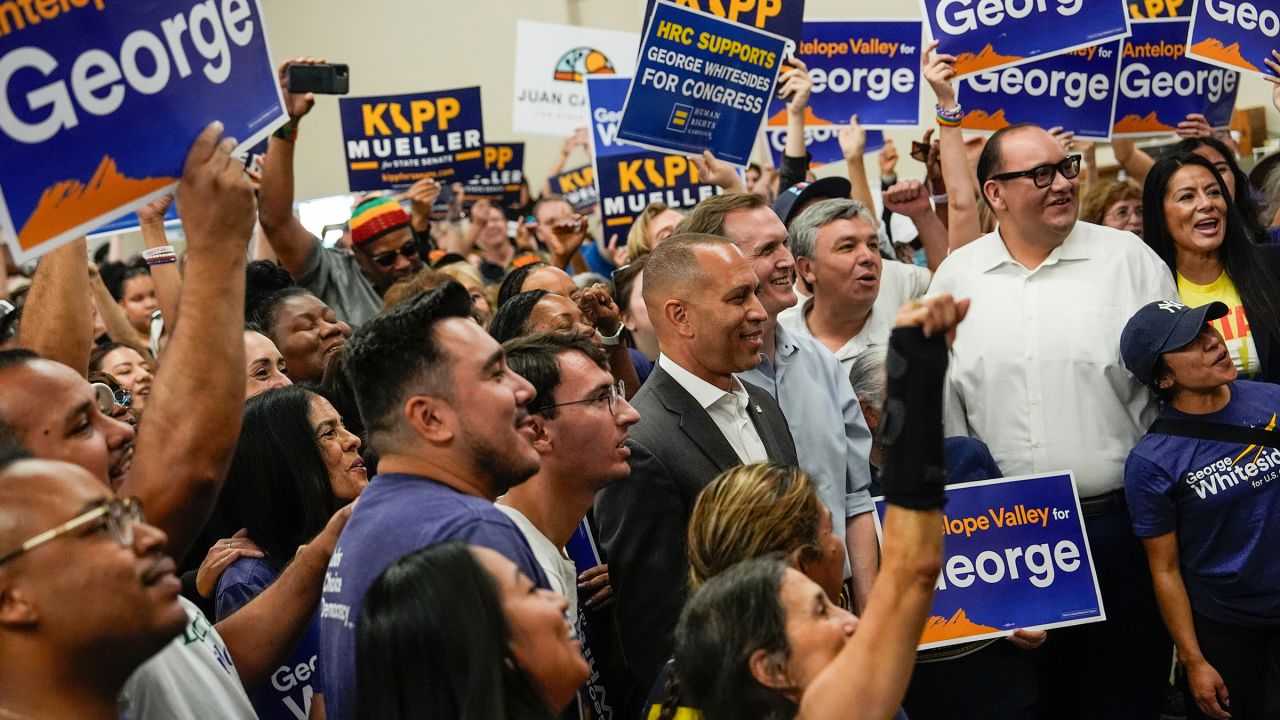 House Minority Leader Hakeem Jeffries poses for a photo with Democrat George Whitesides, to his left, and campaign volunteers in Palmdale, California, on October 13, 2024. Whitesides is challenging Republican Rep. Mike Garcia in California's 27th District.