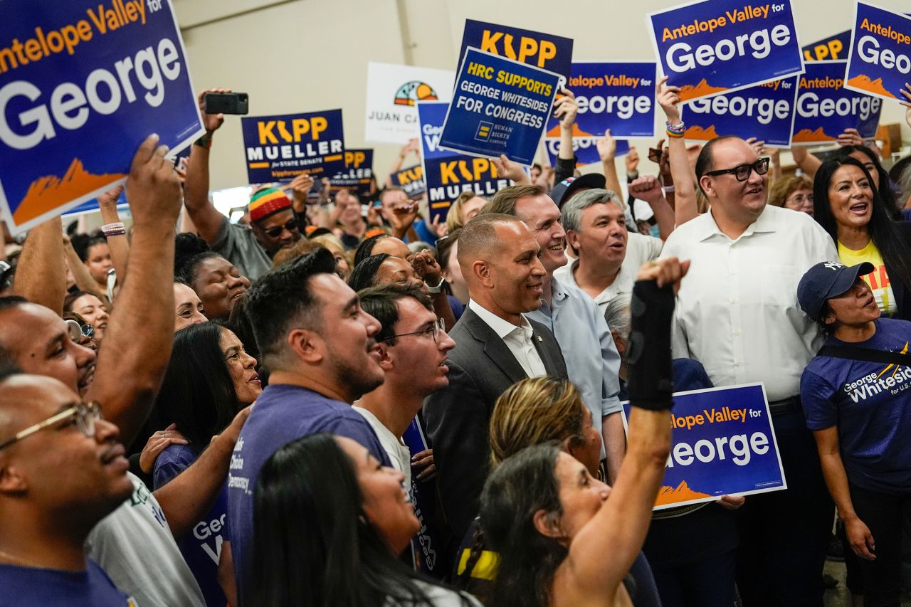 House Minority Leader Hakeem Jeffries poses for a photo with Democrat George Whitesides, to his left, and campaign volunteers in Palmdale, California, on October 13, 2024. Whitesides is challenging Republican Rep. Mike Garcia in California's 27th District.