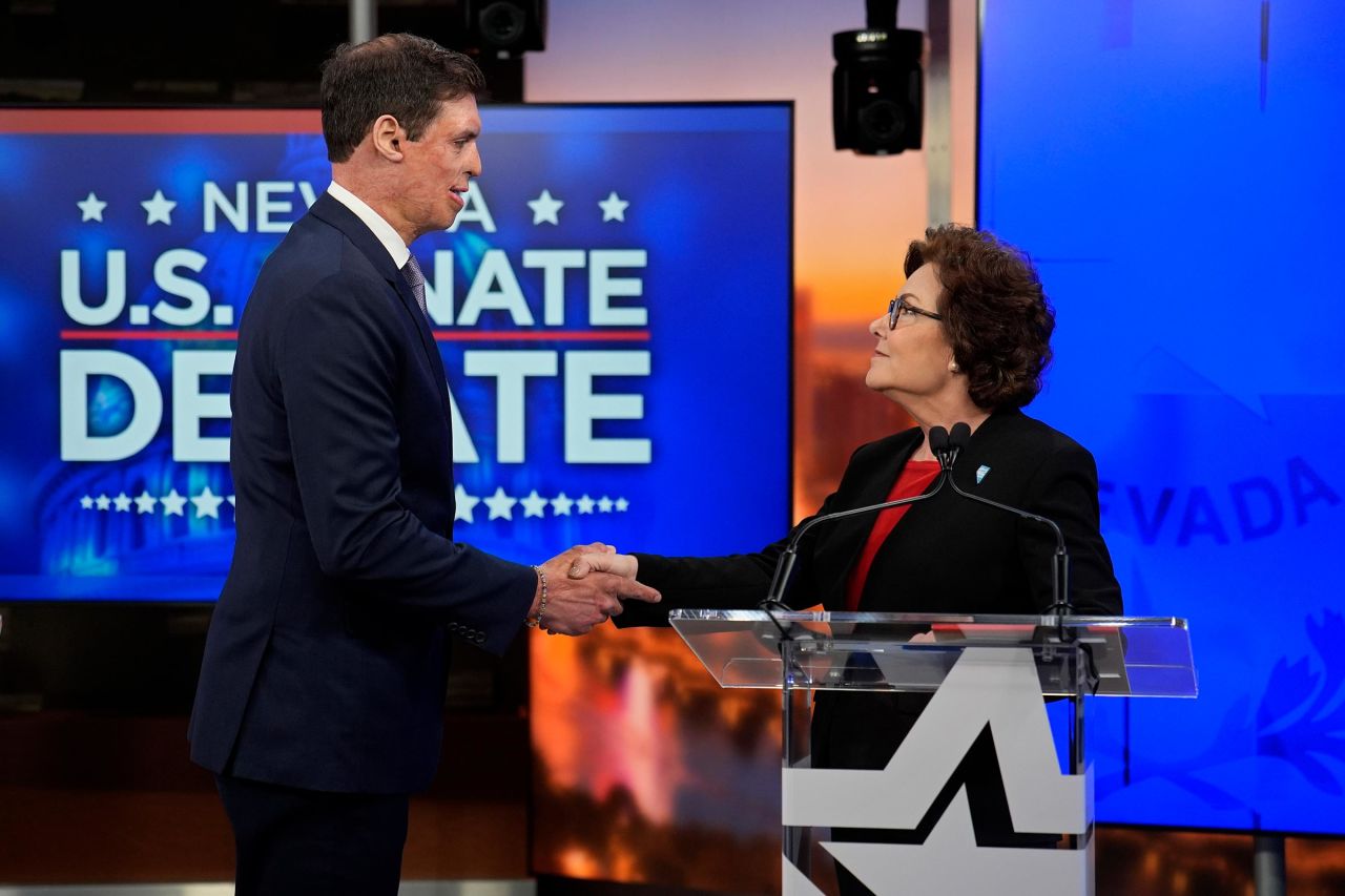 Sam Brown, left, and Sen. Jacky Rosen shake hands before a debate on Thursday, October 17, in Las Vegas.