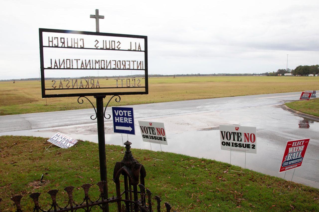 Campaign signs are displayed in front of the All Soul's Church in Scott, Arkansas on Tuesday.