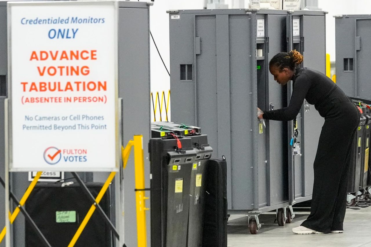 An election staffer works at the Fulton County Election Hub and Operation Center in Atlanta on Tuesday.