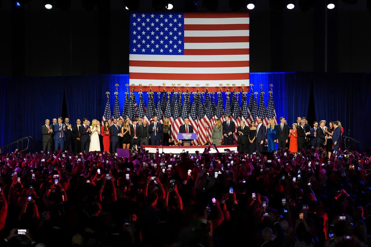 Former President Donald Trump stands on stage joined by his family at the Palm Beach County Convention Center during an election night watch party on November 6 in West Palm Beach, Florida.