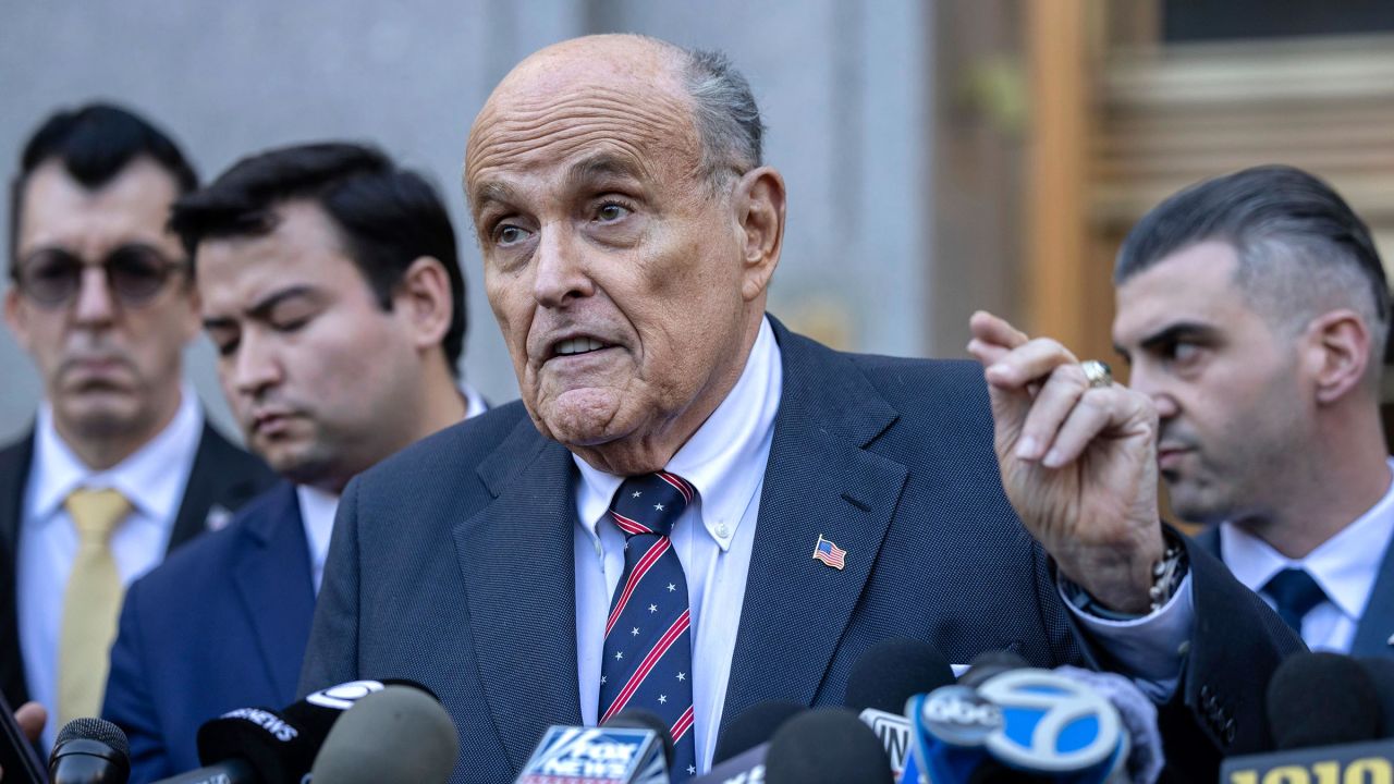 Former New York City Mayor Rudy Giuliani speaks to the members of the media as he leaves court in New York on Thursday, November 7.