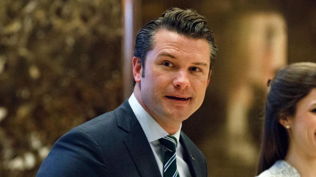 In this 2016 photo, Pete Hegseth walks to an elevator for a meeting with Trump at Trump Tower in New York.