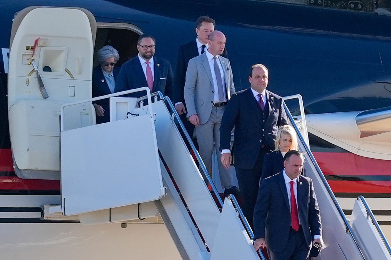 From left, Susie Wiles, Jason Miller, Elon Musk, Stephen Miller, Boris Esphteyn, Natalie Harp and Dan Scavino walk off President-elect Donald Trump's plane on November 13.