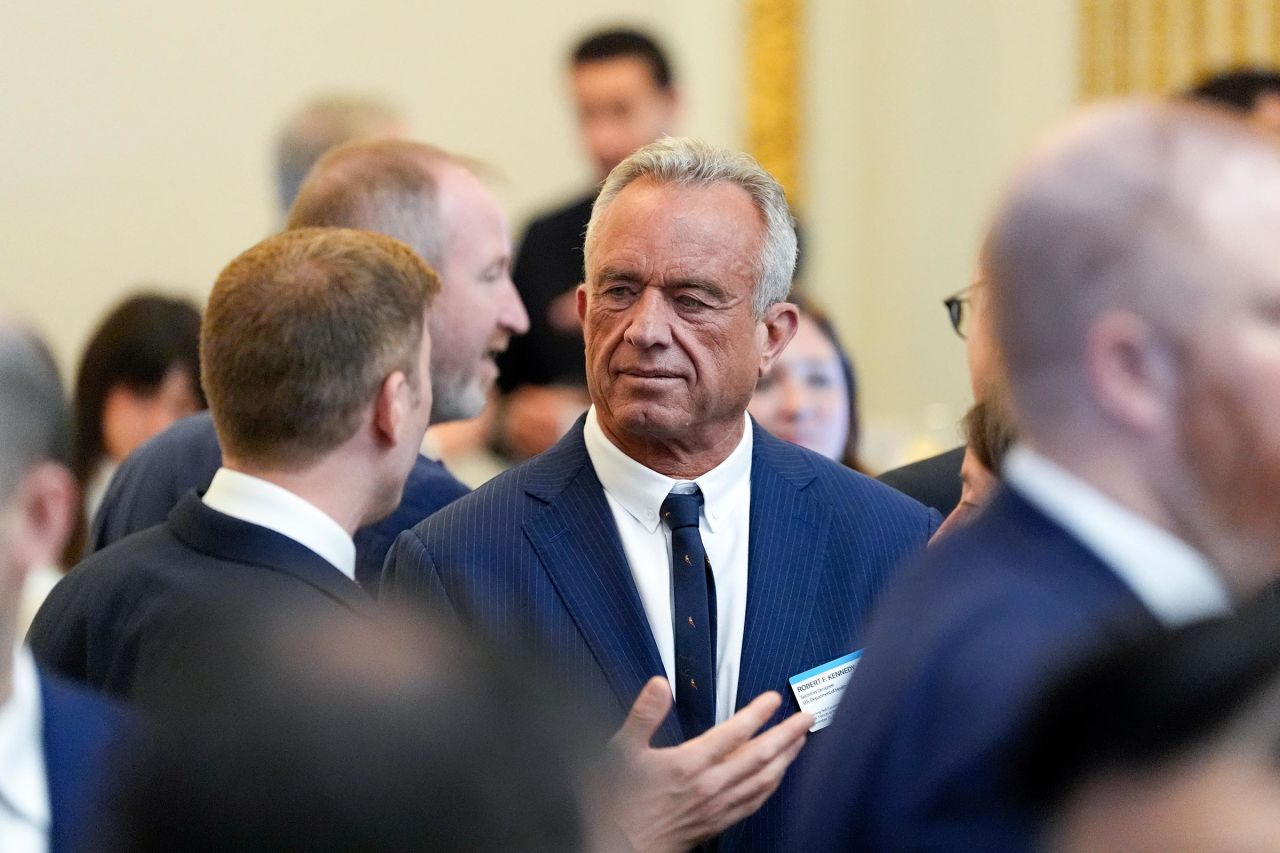 Robert Kennedy Jr. speaks with others before a ceremony with President-elect Donald Trump at the New York Stock Exchange on Thursday December 12, in New York. 