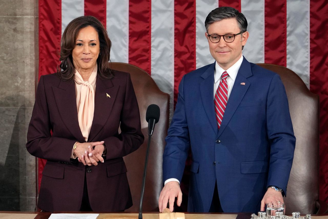 Vice President Kamala Harris stands with House Speaker Mike Johnson as a joint session of Congress convenes to confirm the Electoral College votes, affirming President-elect Donald Trump's victory in the presidential election, on Monday, January 6, in Washington, DC.