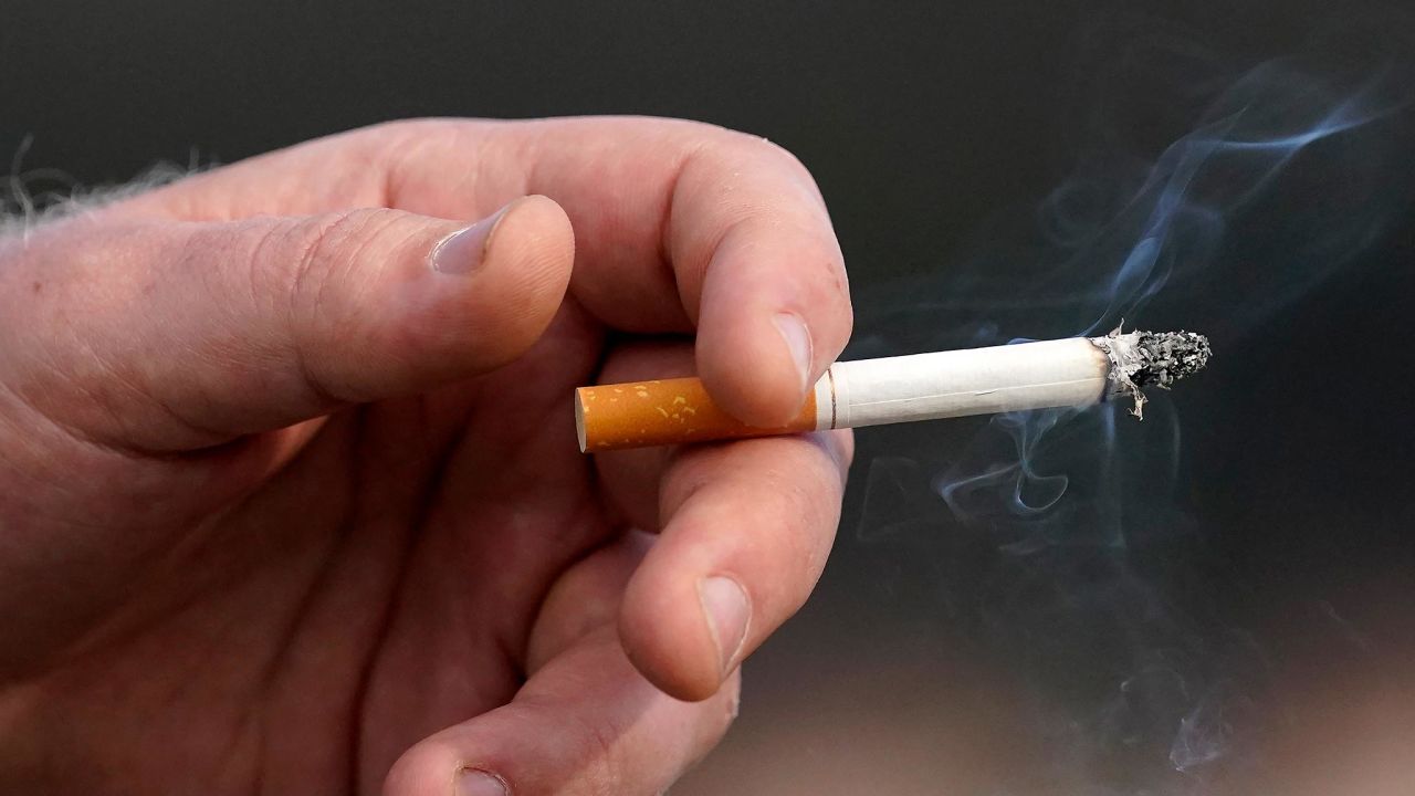 A man holds a lit cigarette while smoking in San Francisco in December 2020. 