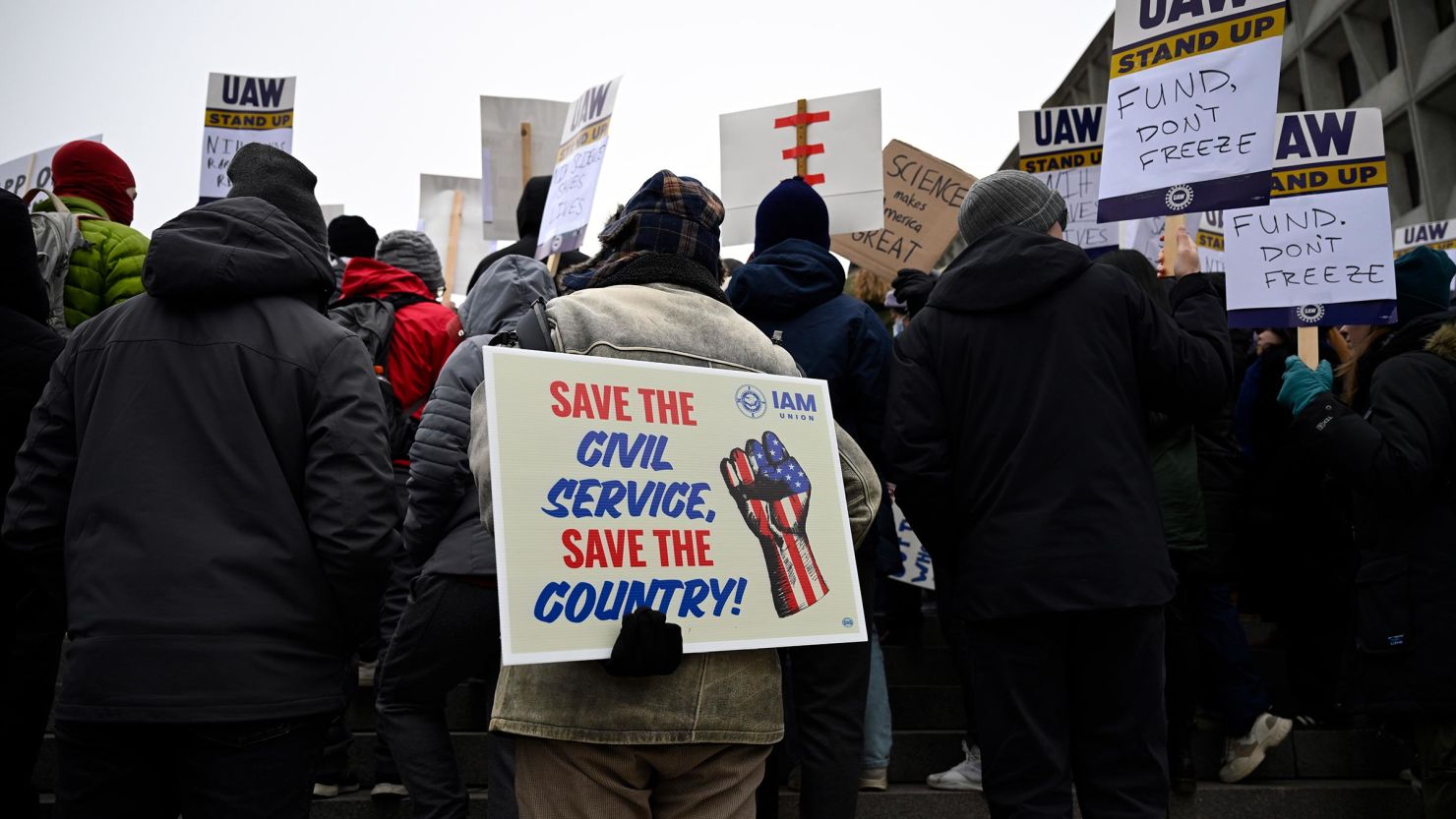 People rally at Health and Human Services headquarters to protest the polices of President Donald Trump and Elon Musk on Wednesday, February 19 in Washington, DC. 