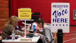 Supervisor of the Checklist for the State of New Hampshire Leslie Dombroski, left, registers Elise Collins, 18, to vote in Derry, New Hampshire, in March.
