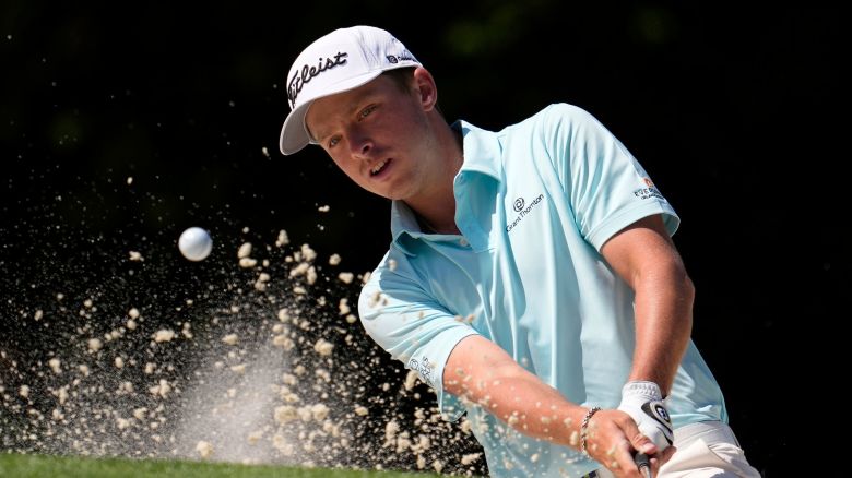 Justin Hastings hits from the bunker on the 10th hole during the first round at the Masters golf tournament on April 10 in Augusta, Georgia.