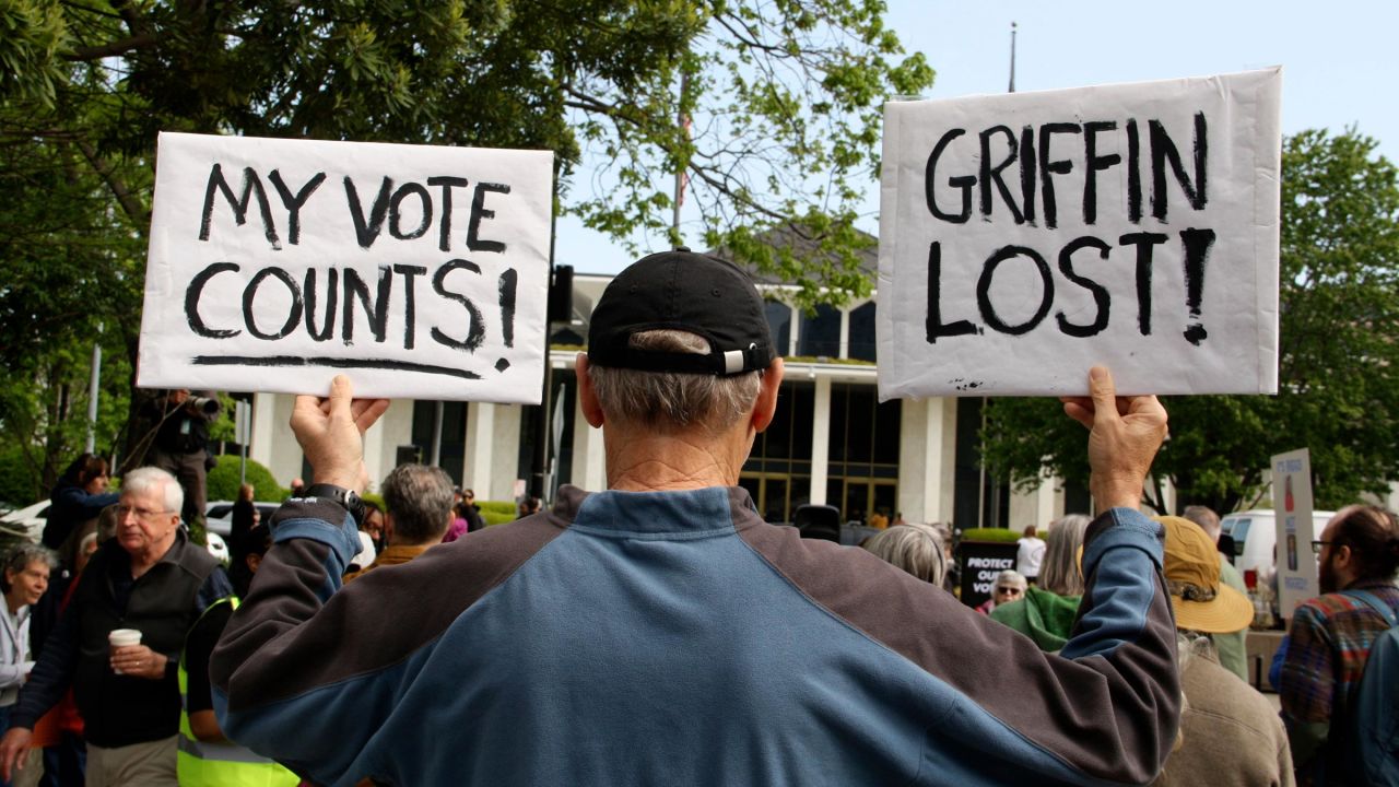 A protester waits for Democratic Associate Justice Allison Riggs to address the crowd in Raleigh, North Carolina on April 14.