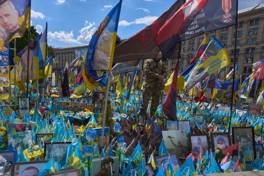 A soldier pays his respect at the memorial to the fallen Ukrainian soldiers on Independence Square in Kyiv, Ukraine, on May 19.