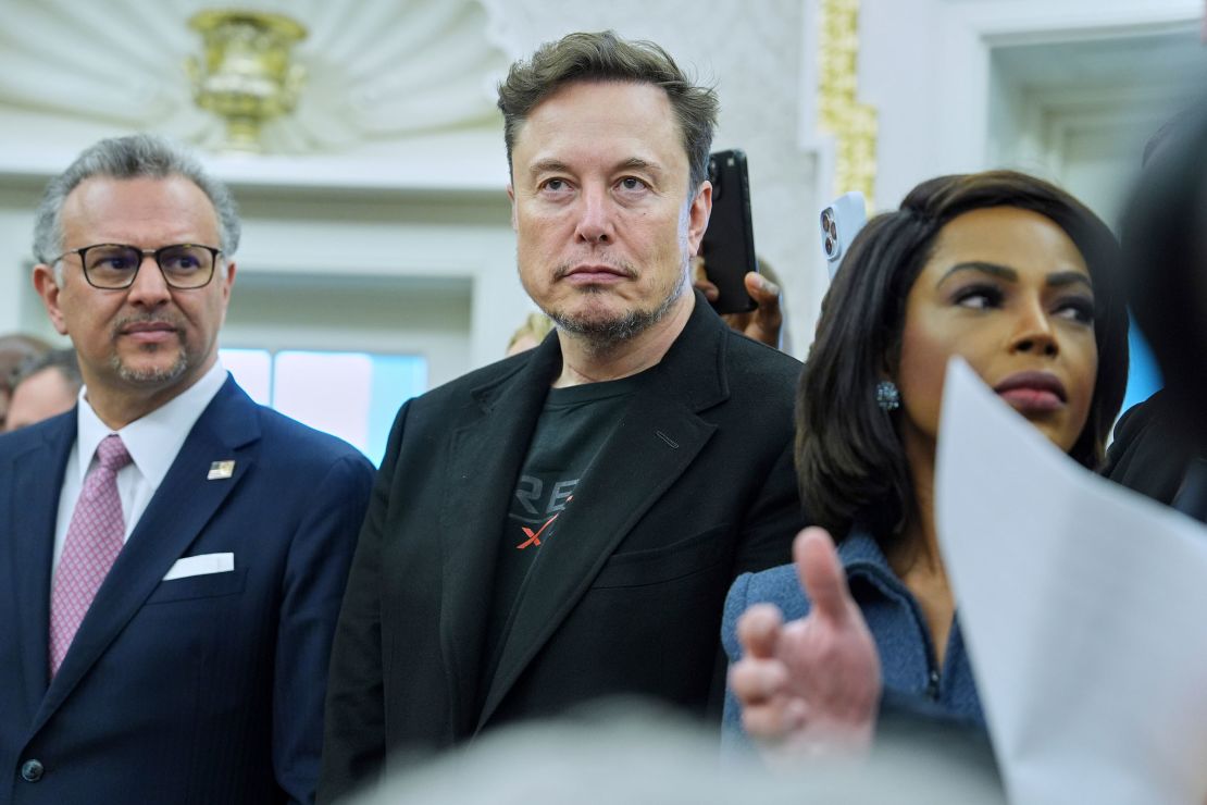 Elon Musk looks on as President Donald Trump meets South African President Cyril Ramaphosa in the Oval Office of the White House on May 21 in Washington, DC.