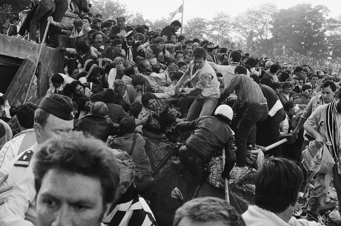 A crowd of soccer fans in the Brussels Heysel stadium, falls down in a heavy group over the broken fence just prior to the European Champion's Cup Final between Liverpool and Juventus of Turin, in Brussels, Belgium, on May 29, 1985. 