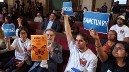 Members of immigration advocacy groups react as Los Angeles City Council votes to enact an ordinance to prohibit city resources from being used for immigration enforcement inside Los Angeles City Hall on November 19, 2024.