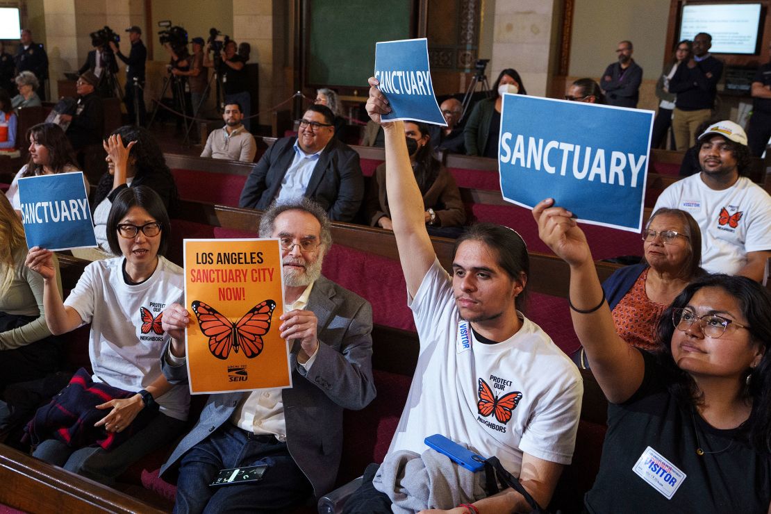 Members of immigration advocacy groups react as Los Angeles City Council votes to enact an ordinance to prohibit city resources from being used for immigration enforcement inside Los Angeles City Hall on November 19, 2024.