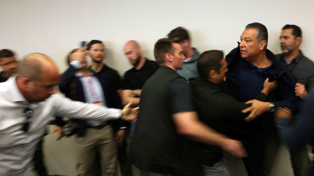 Sen. Alex Padilla is pushed out of the room as Homeland Security Secretary Kristi Noem holds a news conference regarding the recent protests in Los Angeles on June 12.