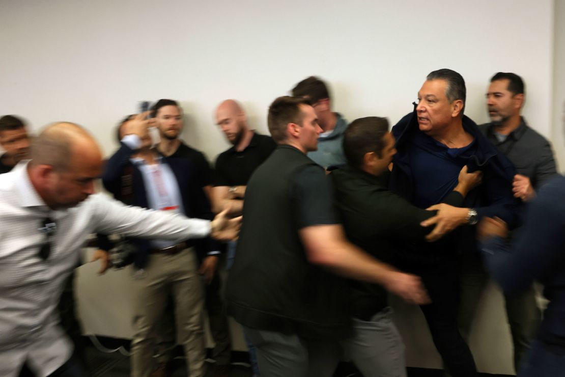Sen. Alex Padilla is pushed out of the room as Homeland Security Secretary Kristi Noem holds a news conference regarding the recent protests in Los Angeles on June 12.