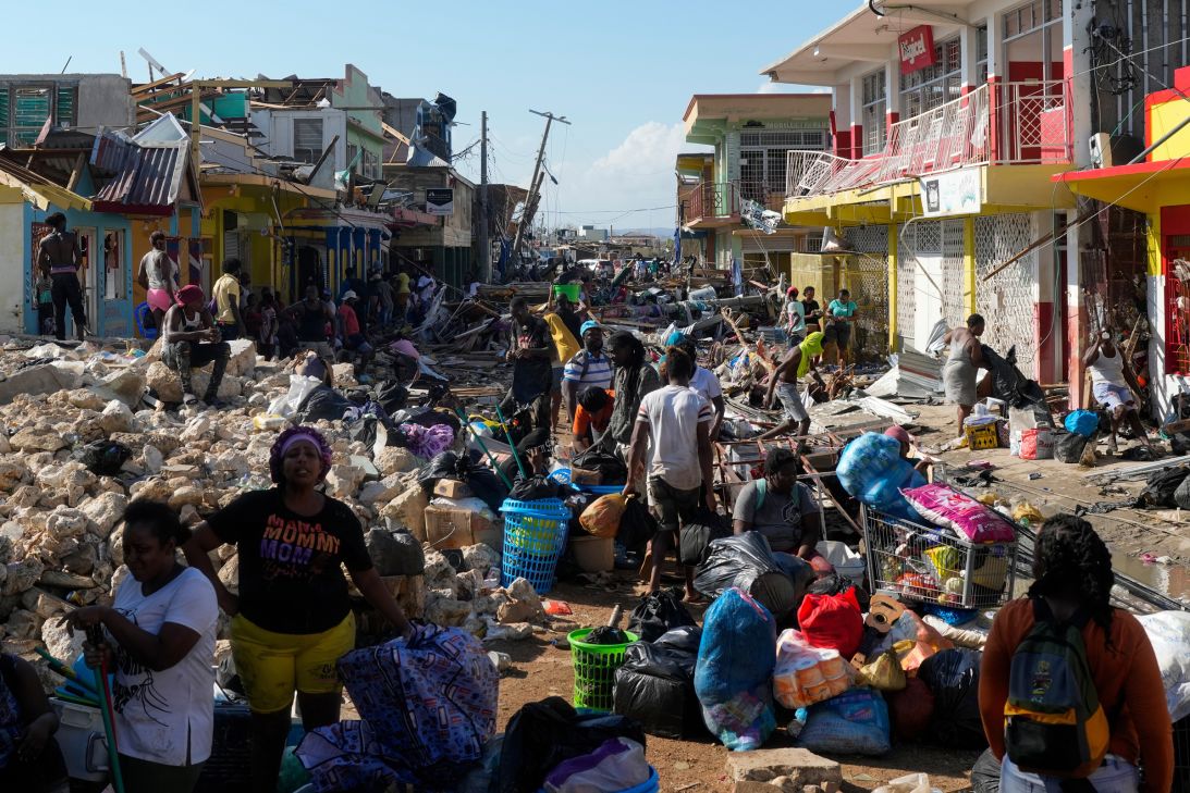 Residents gather amid debris in the aftermath of Hurricane Melissa on a street in Black River, Jamaica, on Thursday.