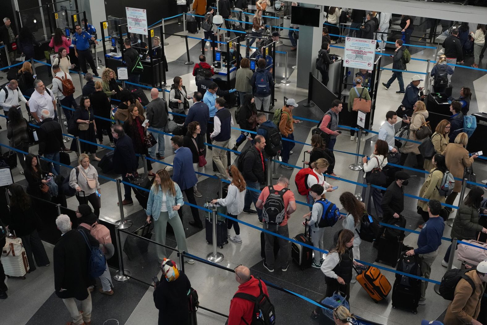 Travelers wait at a security checkpoint at O'Hare International Airport in Chicago on Friday, November 7. <a href="index.php?page=&url=https%3A%2F%2Fwww.cnn.com%2F2025%2F11%2F06%2Fus%2Fflight-cuts-government-shutdown-travel">More than 1,000 flights were canceled</a> on the first day of the Trump administration’s mandatory cuts to reduce US air traffic.