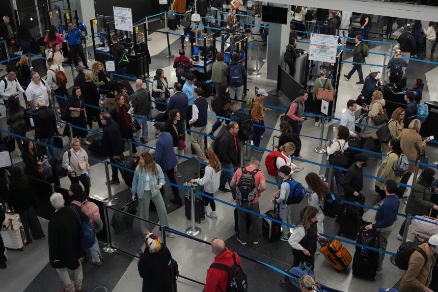 Travelers wait at a security checkpoint at O'Hare International Airport in Chicago, on November 7.
