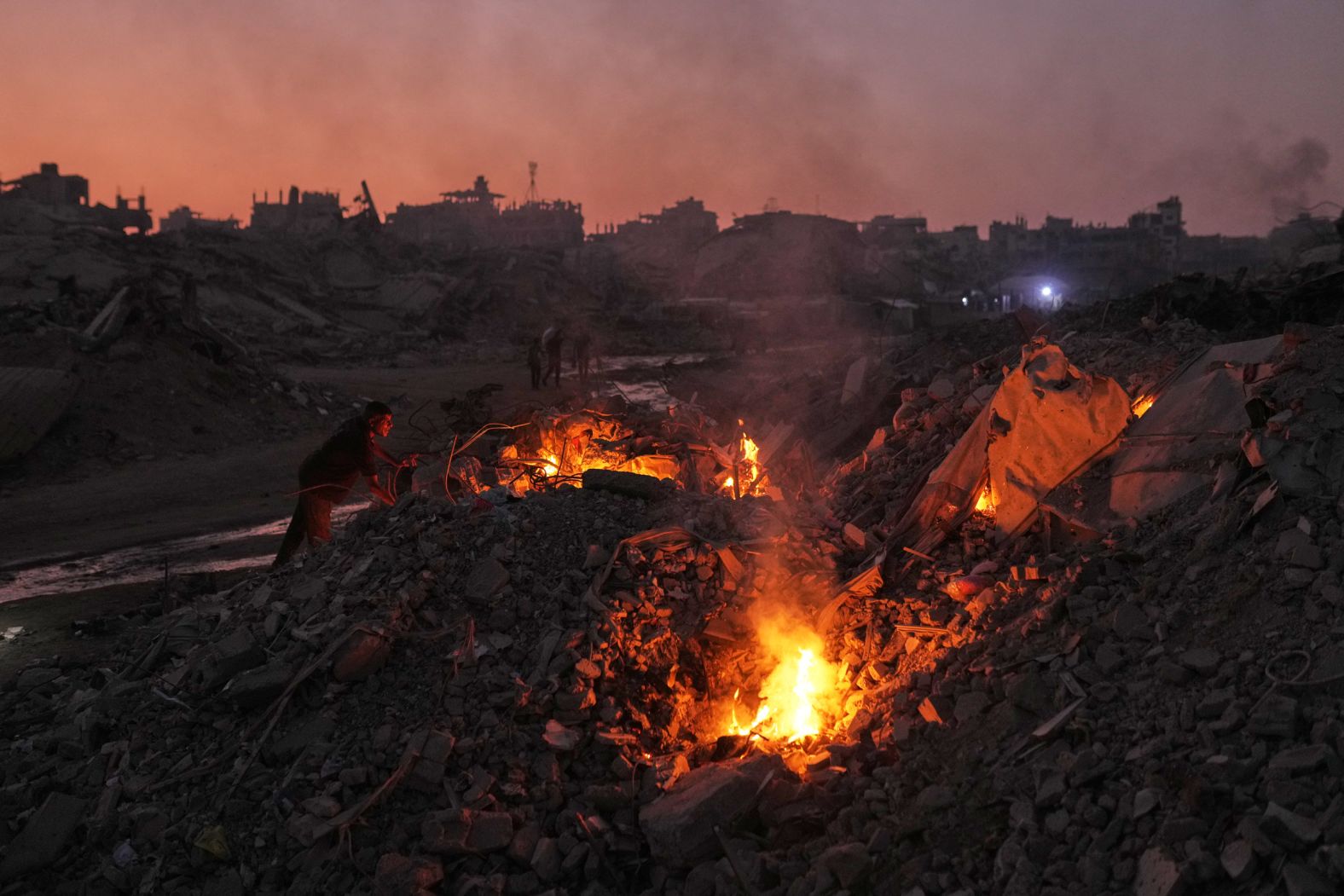 Palestinians in Gaza City light fires to keep away mosquitoes on Monday, November 10. Much of the city has been destroyed by Israeli bombardments since the October 7, 2023 attacks on Israel by Hamas.
