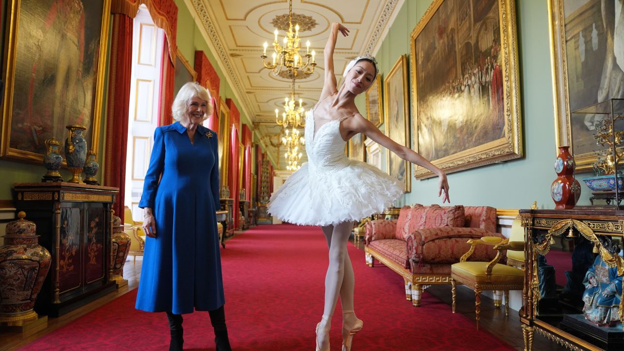 Queen Camilla, left, Patron of the English National Ballet, stands next to Sangeun Lee performing during a reception with staff, dancers, and supporters to celebrate the company's 75th anniversary and recognise the heritage, innovative creation of new works, and their learning and engagement programme, at Buckingham Palace in London, England, Wednesday, Nov. 12, 2025.