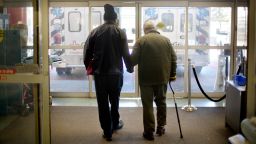 In this 2014 photo, a patient is assisted while walking out of the emergency department at a hospital in Atlanta.