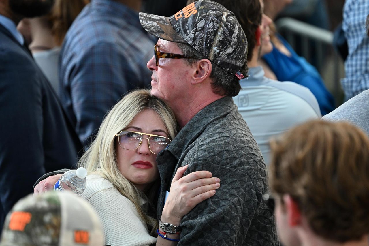 Two people hug during Harris' speech.