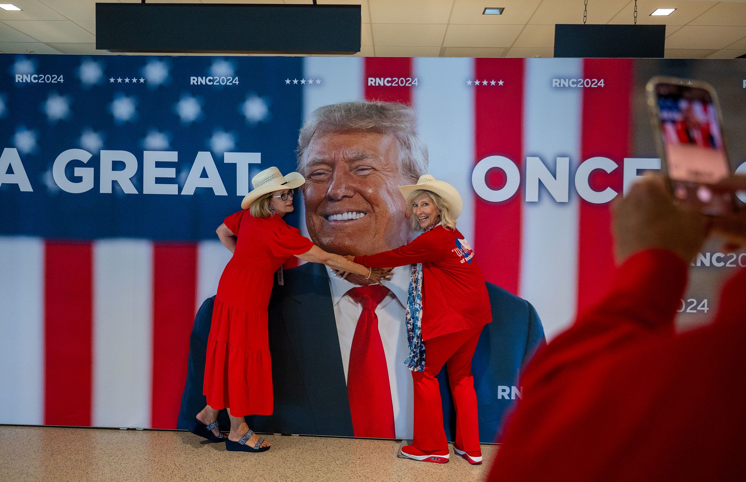 Kay Hall and Sharon Henson, both from Texas, pose with a poster of former US President Donald Trump as they attend the <a href="https://www.cnn.com/2024/07/15/politics/gallery/republican-national-convention/index.html">Republican National Convention</a> in Milwaukee on Monday, July 15.