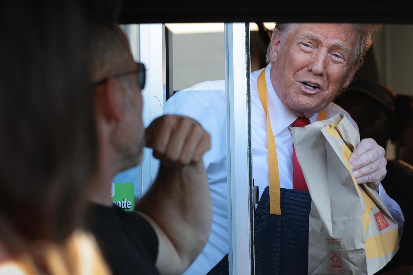 Former President Donald Trump works the drive-through line as he visits a McDonald's restaurant on October 20 in Feasterville-Trevose, Pennsylvania.