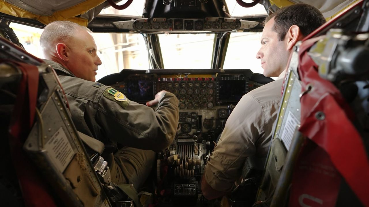 Col. Michael Maginness, commander of the 2nd Bomb Wing, shows CNN's Oren Liebermann, right, the cockpit of a B-52H.