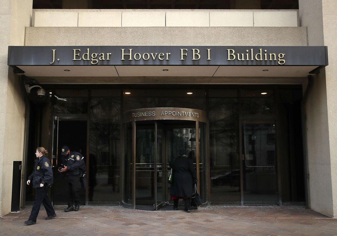 Law enforcement officers walk out of the J. Edgar Hoover FBI Building on January 28, 2019 in Washington, DC. 