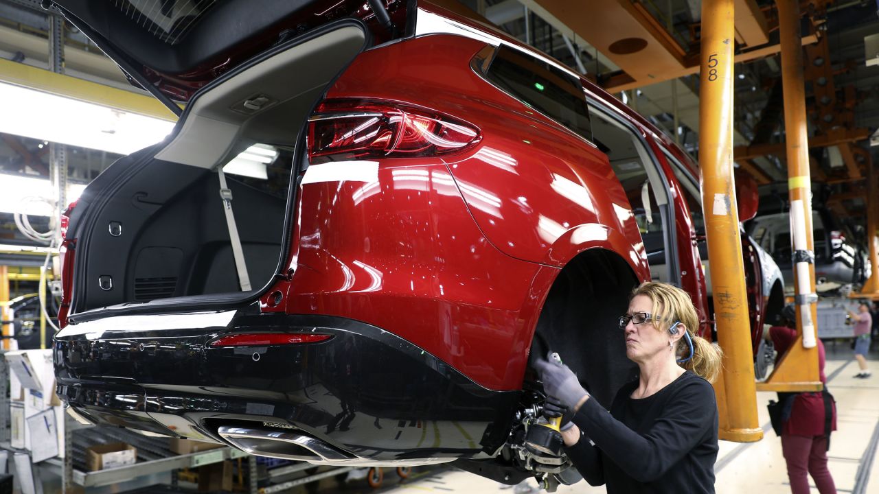 An employee installs components on a vehicle at the General Motors Co. Lansing Delta Township Assembly Plant in Lansing, Michigan, in February 2020.