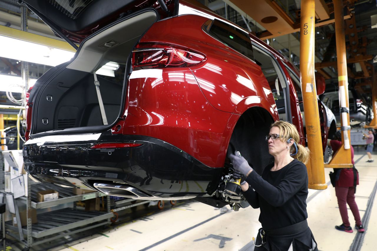 An employee installs components on a vehicle at the General Motors Co. Lansing Delta Township Assembly Plant in Lansing, Michigan, in February 2020.