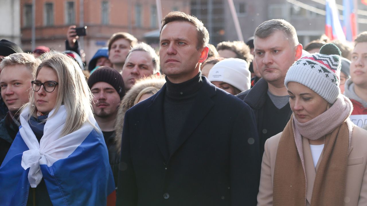 In this February 2020 photo, Alexey Navalny and his wife Yulia walk with demonstrators during a rally in Moscow, Russia.