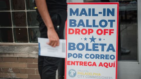 A voter waits to drop off his mail-in ballot at West Oak Lane Library in Philadelphia, Pennsylvania, on Tuesday, June 2, 2020. 