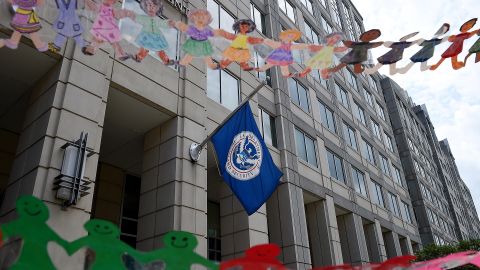 In this July 2020 photo, paper dolls are held by demonstrators protesting outside the Immigration and Customs Enforcement headquarters in Washington, DC.