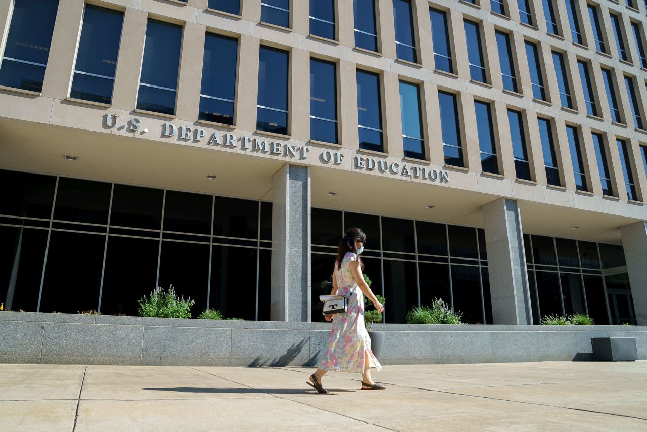 In this August 2020 photo, a person walks past the US Department of Education in Washington, DC. 