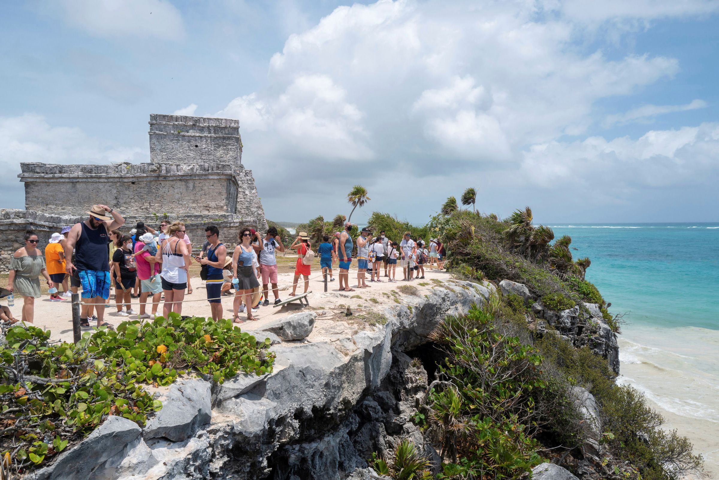 Tourists line up to visit the ruins of the Mayan site with its temples erected in the 13th century, on April 10, 2021.