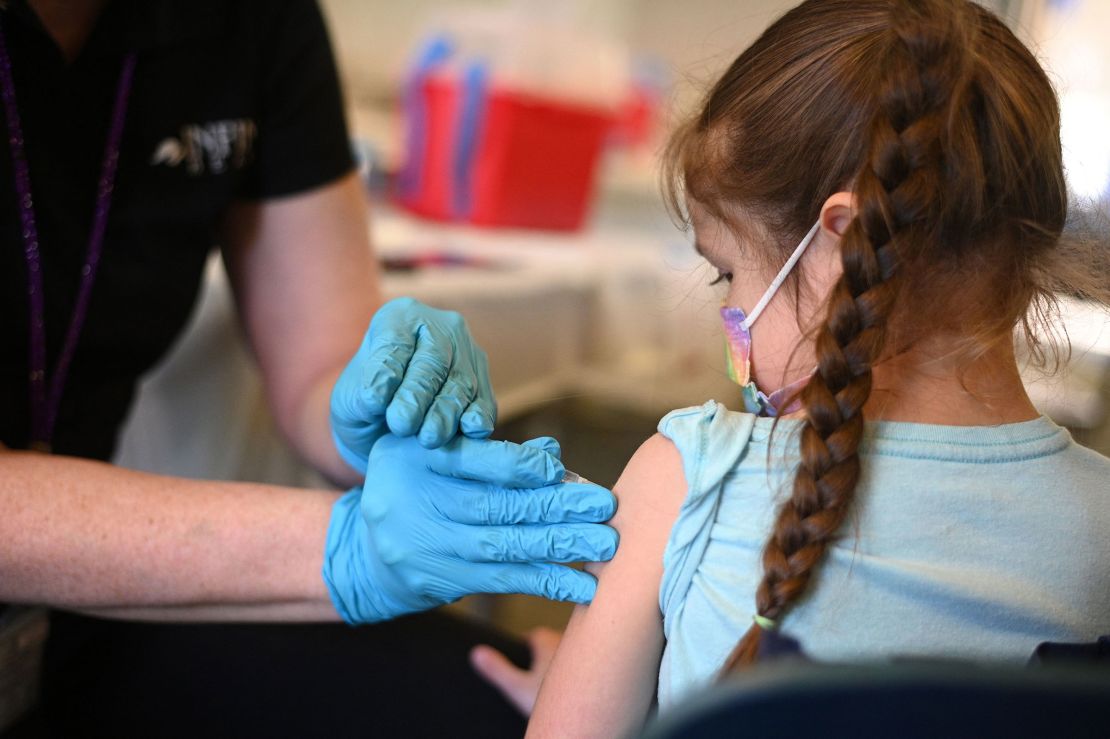 In this January 2022 photo, a nurse administers a pediatric dose of the Covid-19 vaccine to a girl at a clinic at Los Angeles Mission College in the Sylmar neighborhood in Los Angeles.