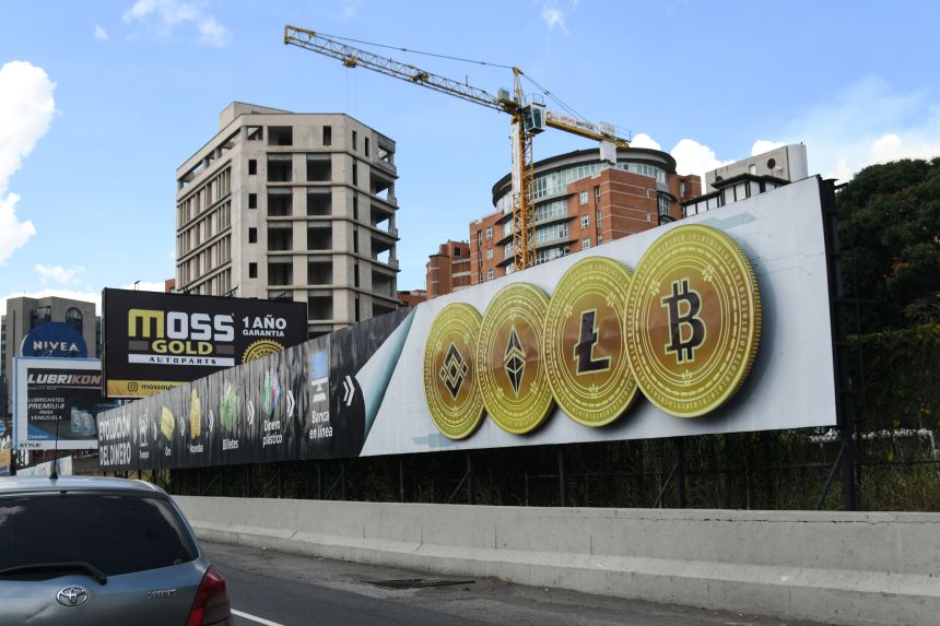 A sign displaying Binance tokens, from left, Ethereum, Litecoin, and Bitcoin cryptocurrencies, in Caracas, Venezuela, on February 1, 2022.