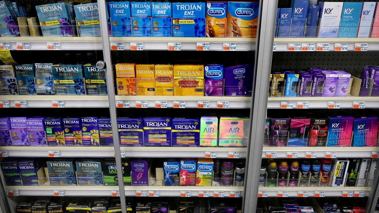 This February 2022 photo shows packs of various condoms on a shelf of a convenience store in Washington, DC.